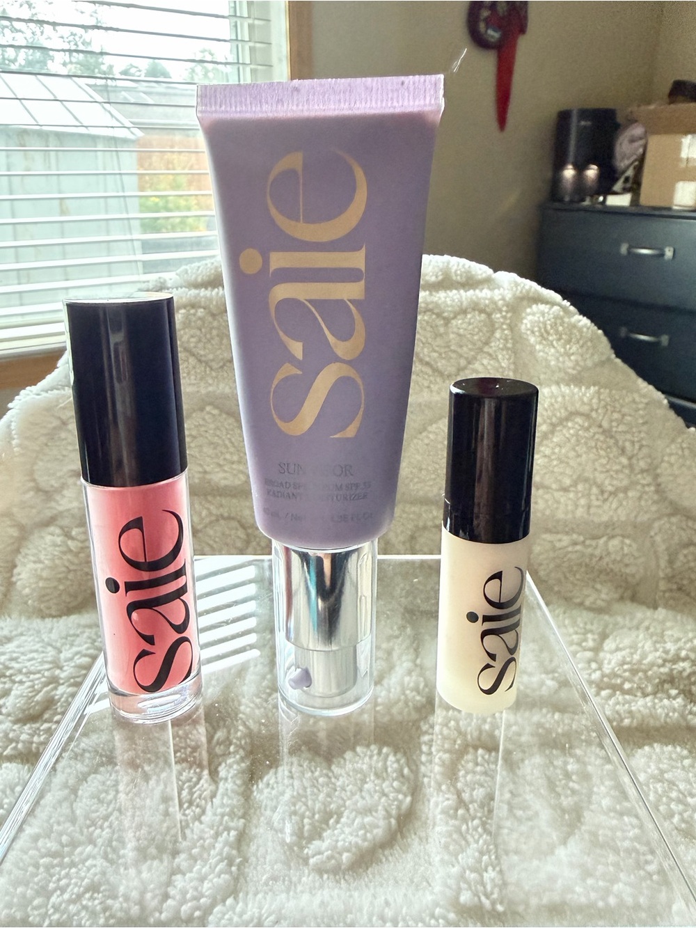 Saie Pink Lip Gloss &  radiant sun moisturizer and mini highlight
